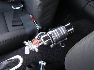 Polished aluminum racing style fire extinguisher mounted between the front seats.