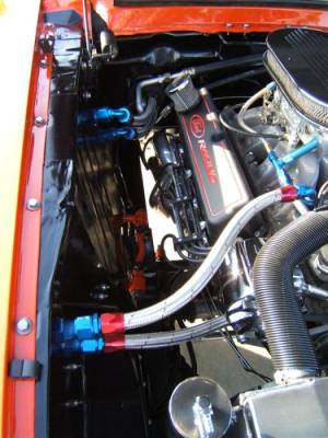 The shock towers have been shaved, allowing for plenty of room for the ceramic coated hooker long tube headers. You will also notice that heater hoses runner out of the engine compartment and under the fenders.